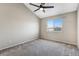 This is a large bedroom with vaulted ceiling and a window offering a view of the neighborhood at 13025 W 63Rd Pl # C, Arvada, CO 80004