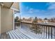 Snowy wood deck shows outdoor living and neighborhood view with clear blue sky at 13025 W 63Rd Pl # C, Arvada, CO 80004