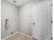 Practical laundry area featuring tile flooring, utility connections, and a white paneled door at 13025 W 63Rd Pl # C, Arvada, CO 80004