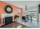 Inviting dining area with fireplace, pendant lighting, and sliding glass doors to the backyard at 879 S Hudson St, Denver, CO 80246