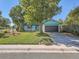 Ranch home with teal and white exterior and a neatly landscaped yard at 879 S Hudson St, Denver, CO 80246