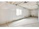 Unfinished basement with visible utilities, a window, and vapor barrier walls at 5726 N Jebel Way, Aurora, CO 80019