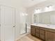 Bathroom with double vanity, wood-look floors, and glass shower at 5726 N Jebel Way, Aurora, CO 80019