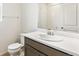This bathroom showcases a modern vanity, a clean toilet, and a large mirror at 5726 N Jebel Way, Aurora, CO 80019