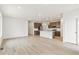 Modern kitchen with stainless steel appliances, a large island, and beautiful light wood floors at 5726 N Jebel Way, Aurora, CO 80019