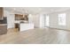 Open-concept kitchen and living area with wood floors and a center island, perfect for entertaining at 5726 N Jebel Way, Aurora, CO 80019