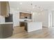 Modern kitchen featuring stainless steel appliances, a center island, and stylish pendant lighting fixtures at 5726 N Jebel Way, Aurora, CO 80019