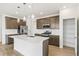 Modern kitchen with stainless steel appliances, a large island, and a pantry at 5726 N Jebel Way, Aurora, CO 80019