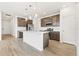 Modern kitchen with stainless steel appliances, an island with a sink, and beautiful pendant lighting at 5726 N Jebel Way, Aurora, CO 80019