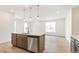 Open-concept kitchen with stainless steel dishwasher and large island at 5726 N Jebel Way, Aurora, CO 80019