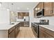 Modern kitchen with stainless steel appliances, island, and plenty of cabinet space at 5726 N Jebel Way, Aurora, CO 80019