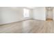 Bright and spacious living room with large windows and wood-look flooring, providing a cozy atmosphere at 5726 N Jebel Way, Aurora, CO 80019