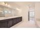 Modern bathroom with double vanity, sleek fixtures, and a large mirror at 11452 Autumn Moon St, Littleton, CO 80125