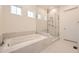 Luxurious bathroom featuring a soaking tub and a glass-enclosed shower at 11452 Autumn Moon St, Littleton, CO 80125