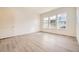 A well-lit bedroom featuring light gray wood flooring and several large windows at 11452 Autumn Moon St, Littleton, CO 80125