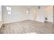 A well-lit bedroom featuring light gray wood flooring, white walls, and a walk-in closet at 11452 Autumn Moon St, Littleton, CO 80125