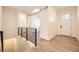 Modern hallway with wood floors, iron railing, and barn doors at 11452 Autumn Moon St, Littleton, CO 80125