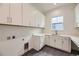 Well-lit laundry room featuring modern appliances and ample storage space at 11452 Autumn Moon St, Littleton, CO 80125
