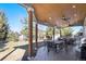 Spacious covered patio with outdoor dining area and ceiling fans, perfect for entertaining at 23453 Painted Hills St, Parker, CO 80138
