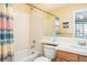 Bathroom with tile surround tub and shower, and a large mirror above the sink at 23453 Painted Hills St, Parker, CO 80138