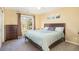 Comfortable bedroom includes soft carpet, a large bed, a double-hung window, and a dresser for storage at 23453 Painted Hills St, Parker, CO 80138