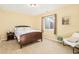 Bedroom with large window, bedside table, and sitting area at 23453 Painted Hills St, Parker, CO 80138