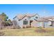 Charming home featuring brick and light blue siding, arched windows and attached garage at 23453 Painted Hills St, Parker, CO 80138