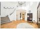 Bright foyer features hardwood floors, staircase, hall tree, and soaring ceilings with an attractive light fixture at 23453 Painted Hills St, Parker, CO 80138