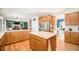 Open kitchen with stainless steel appliances and granite countertops leading to the dining area at 23453 Painted Hills St, Parker, CO 80138