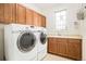 Well-equipped laundry room with washer, dryer, utility sink, and cabinet storage at 23453 Painted Hills St, Parker, CO 80138
