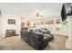 Spacious living room with cozy carpet, ceiling fan, and open view to the dining area and kitchen at 23453 Painted Hills St, Parker, CO 80138