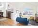 Open-concept living room featuring hardwood floors, vaulted ceiling, and plenty of natural light at 23453 Painted Hills St, Parker, CO 80138