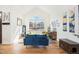 Bright living room featuring hardwood floors, vaulted ceiling, and a large window offering ample natural light at 23453 Painted Hills St, Parker, CO 80138