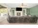 Cozy living room with a fireplace, built-in shelving, and large windows, creating a warm and inviting atmosphere at 23453 Painted Hills St, Parker, CO 80138