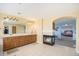 Bright bathroom with tiled floors, a long vanity with double sinks, and an archway into the main bedroom at 23453 Painted Hills St, Parker, CO 80138