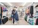 Spacious walk-in closet with custom shelving, carpet flooring, and ample storage for clothing and accessories at 23453 Painted Hills St, Parker, CO 80138
