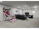 Finished basement featuring couch, TV area, and a basketball game at 9487 Winding Hill Way, Lone Tree, CO 80124