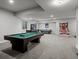 Spacious finished basement with a billiards table and an arcade game setup at 9487 Winding Hill Way, Lone Tree, CO 80124