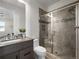 Bathroom featuring glass shower, modern vanity, and mosaic tile accents at 9487 Winding Hill Way, Lone Tree, CO 80124