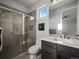 Bathroom featuring glass shower, modern vanity, and mosaic tile accents at 9487 Winding Hill Way, Lone Tree, CO 80124