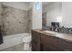 Bathroom featuring tub, modern vanity with stylish wooden finish, and mosaic tile accents at 9487 Winding Hill Way, Lone Tree, CO 80124