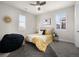 Bedroom featuring yellow bedding, a bean bag chair, and light from two large windows at 9487 Winding Hill Way, Lone Tree, CO 80124