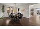 Dining room with modern lighting, dark wood floors, and seating for six at 9487 Winding Hill Way, Lone Tree, CO 80124