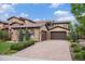 Exterior view of a beautiful home featuring stone accents, a tile roof, and a three-car garage at 9487 Winding Hill Way, Lone Tree, CO 80124
