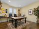 Bright home office featuring hardwood floors and built-in shelving units at 9487 Winding Hill Way, Lone Tree, CO 80124