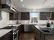 Contemporary kitchen with custom cabinets, stainless steel appliances, and wood floors for a sleek design aesthetic at 9487 Winding Hill Way, Lone Tree, CO 80124