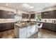 Modern kitchen with stainless steel appliances, a large island, and custom cabinets for an open and inviting space at 9487 Winding Hill Way, Lone Tree, CO 80124