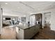 Open-concept kitchen with a large island, stainless steel appliances, and seamless flow to the living and dining areas at 9487 Winding Hill Way, Lone Tree, CO 80124