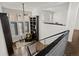 Cozy living room with modern chandelier, window seating, and stylish decor at 9487 Winding Hill Way, Lone Tree, CO 80124