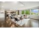 Bright living room featuring modern furniture, large windows offering scenic views, and hardwood floors throughout the area at 9487 Winding Hill Way, Lone Tree, CO 80124
